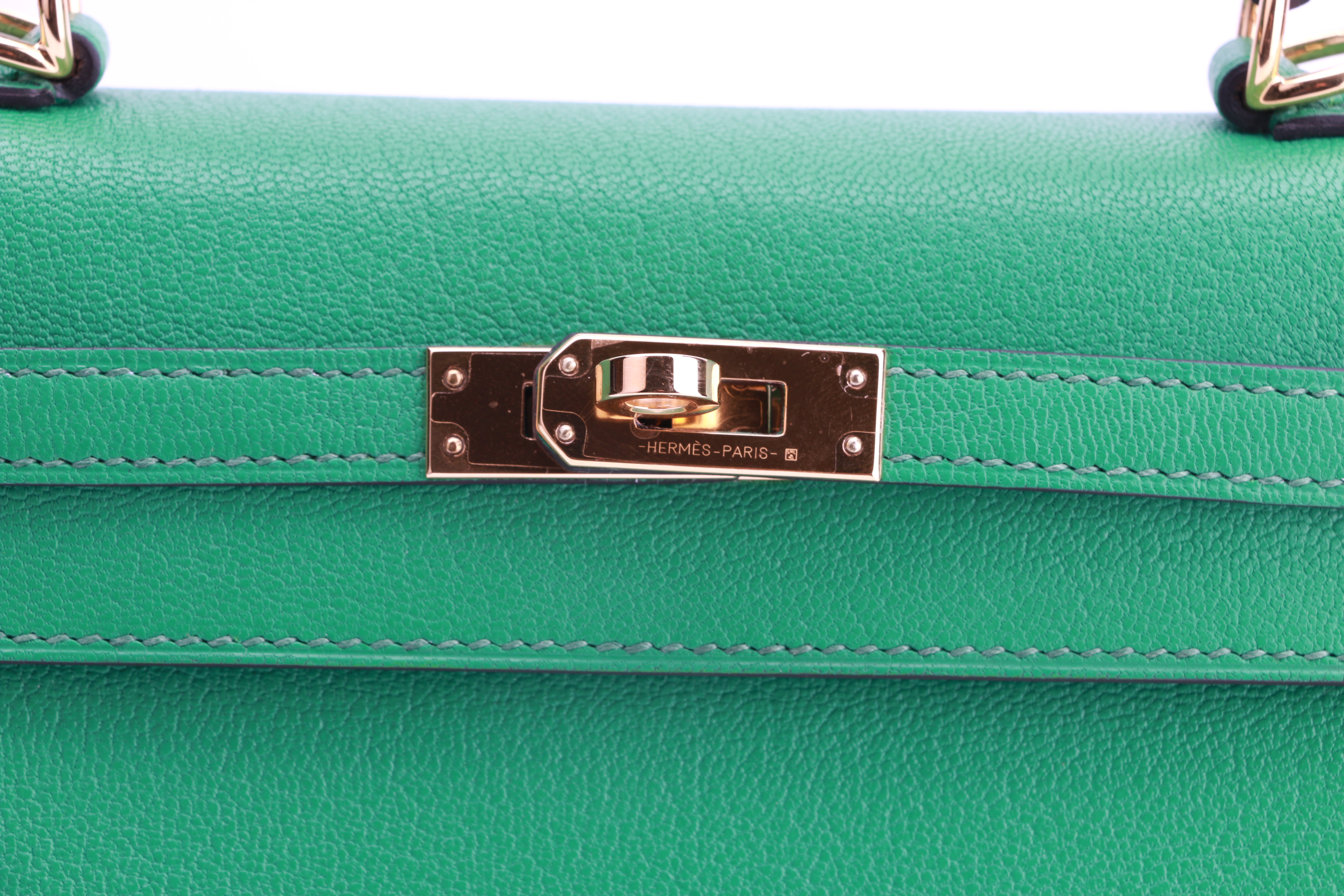 Replica Kelly Sellier closure detail showing the flap, sangles and turn-lock Replica Kelly Sellier closure detail showing the flap, sangles and turn-lock