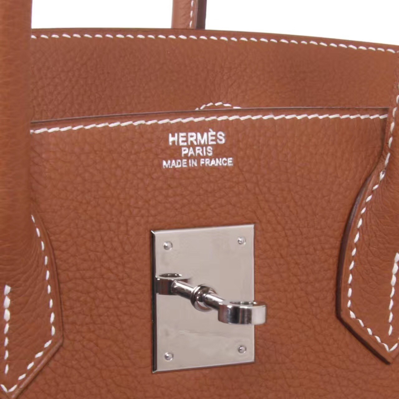 Brown Togo leather stamp and lock detail from TheCovetedLuxury